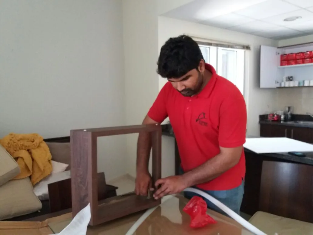 Expert Movers packers wrapping and protecting furniture during an Abu Dhabi villa move